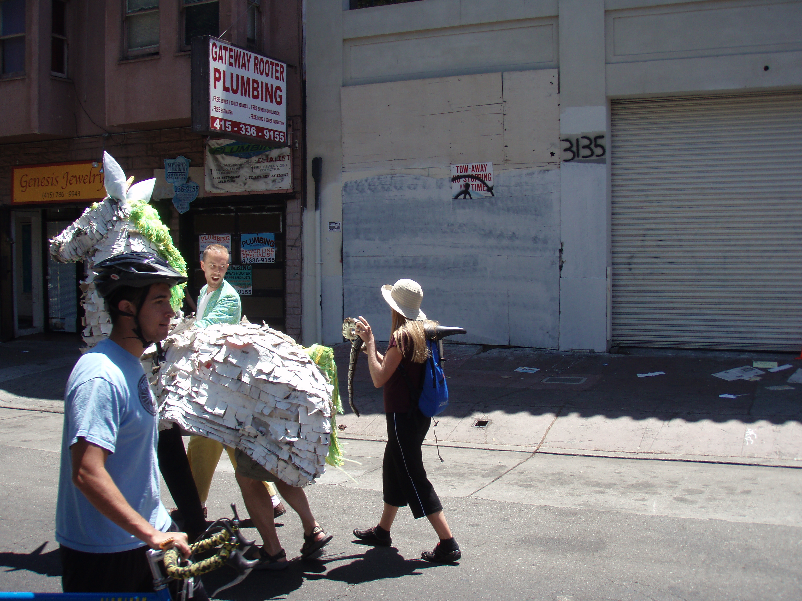 Sunday Streets - Unicorn and a snake After stopping off at Pop's for a refreshment, I stumbled across a unicorn walking down the street with a crazy lady chasing them with a snake. I immediately became concerned that the bartender drugged me and I was tripping balls. After some passersby checked my pupils to confirm my sobriety, I watched in awe as the woman tried to mount the snake on the back of the unicorn, much to the apparent protest of the humans inside the unicorn.
